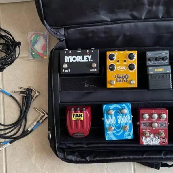 multiple guitar effects pedals with pedal board