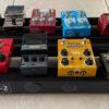 multiple guitar effects pedals with pedal board